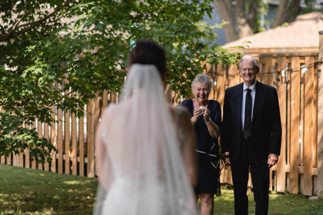bride having first look with parents on wedding day