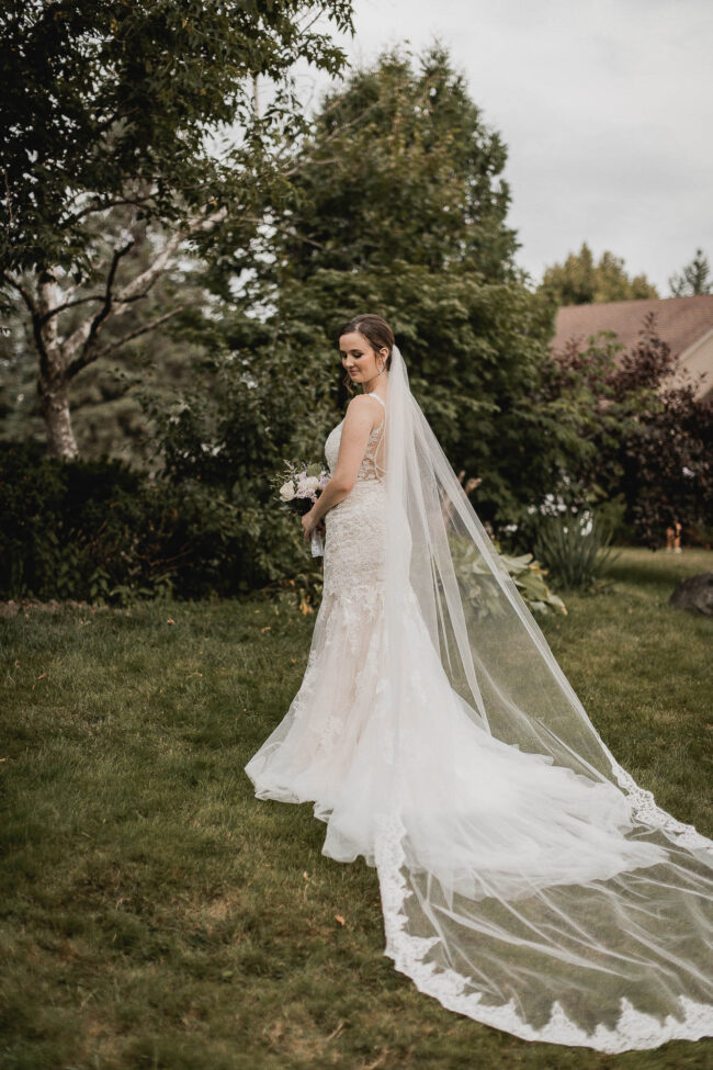 bride with long train and veil on wedding day