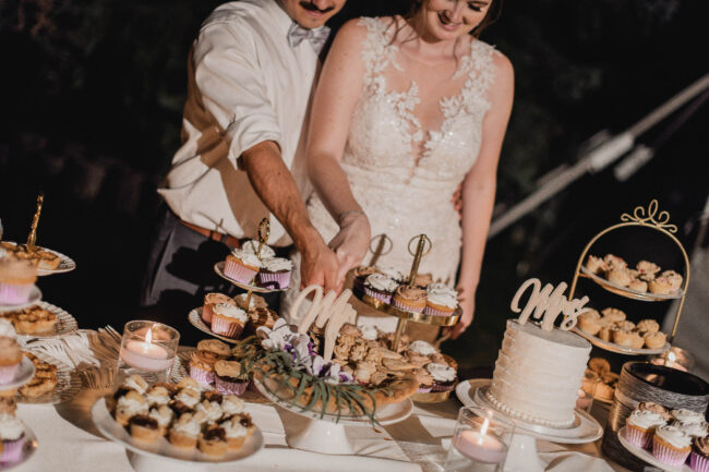 bride and groom cutting cake