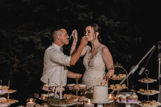 bride and groom cutting cake