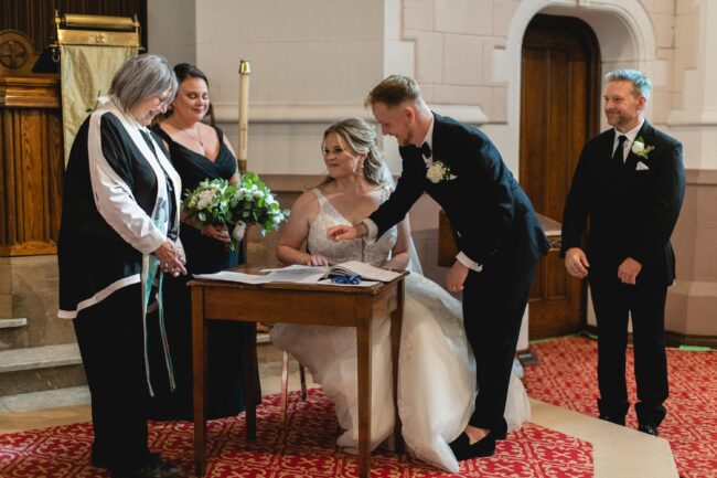 bride and groom signing paperwork