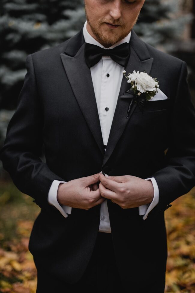 groom doing up his tux