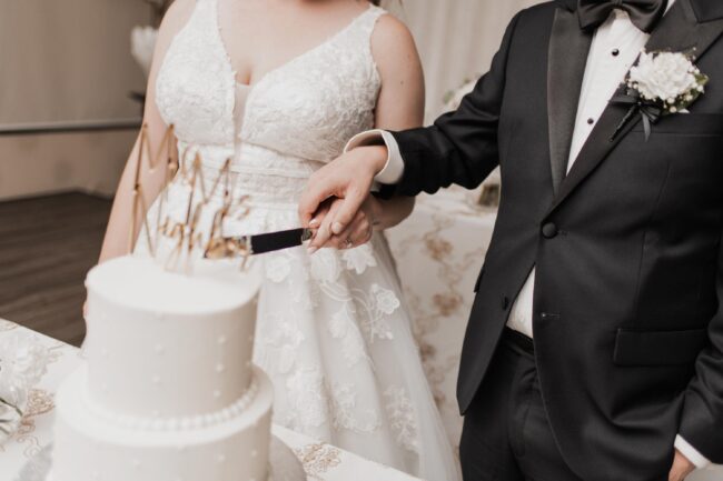 bride and groom cut wedding cake