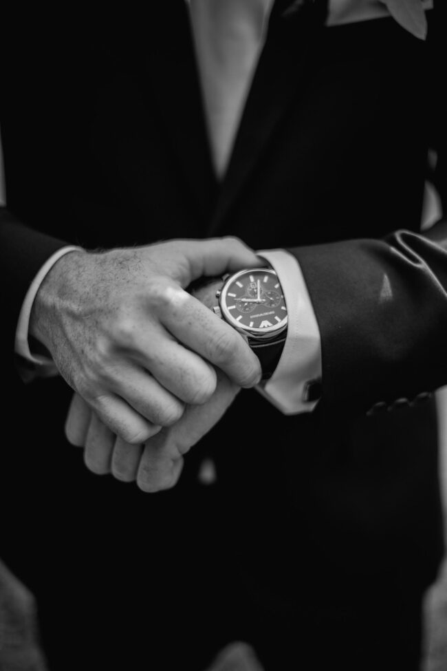 groom adjusting watch