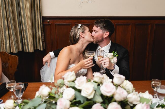 bride and groom kissing at wedding reception